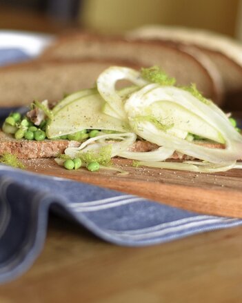 Auf dem Foto ist ein Brot zu sehen, das mit Apfel, Erbsen und Fenchel belegt ist. | © SONNENTOR